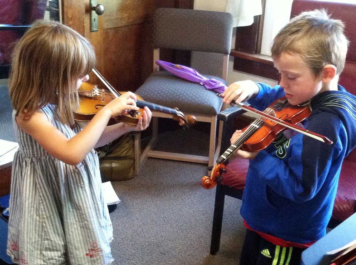 Sol Holmquist and Nolan Wickland practice at North Valley Music School.