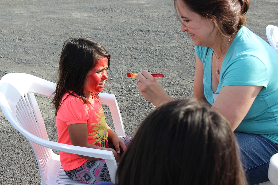 Chanet Stevenson/The Sun Tribune - 5-year-old, Aaliyah, gets her face painted like a lady bug.