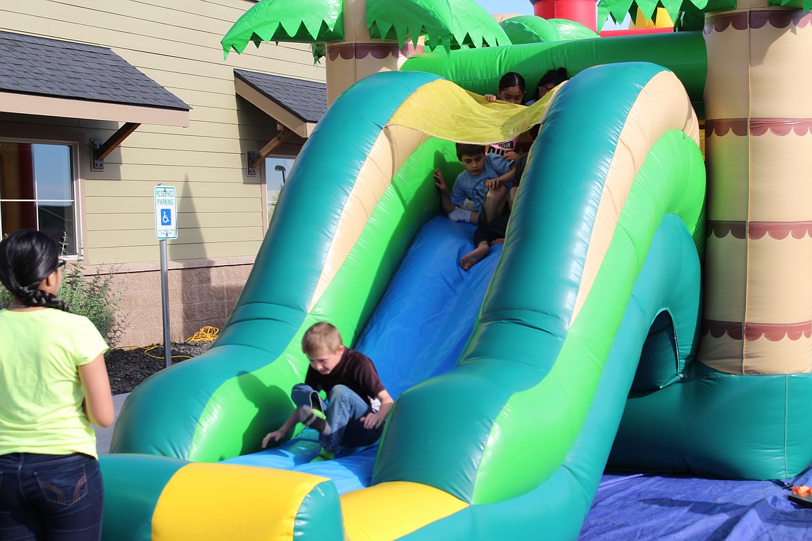 Chanet Stevenson/The Sun Tribune - With two bouncy houses to choose from, there was no shortage of fun for the kids who attended the 2nd annual Othello Community BBQ.