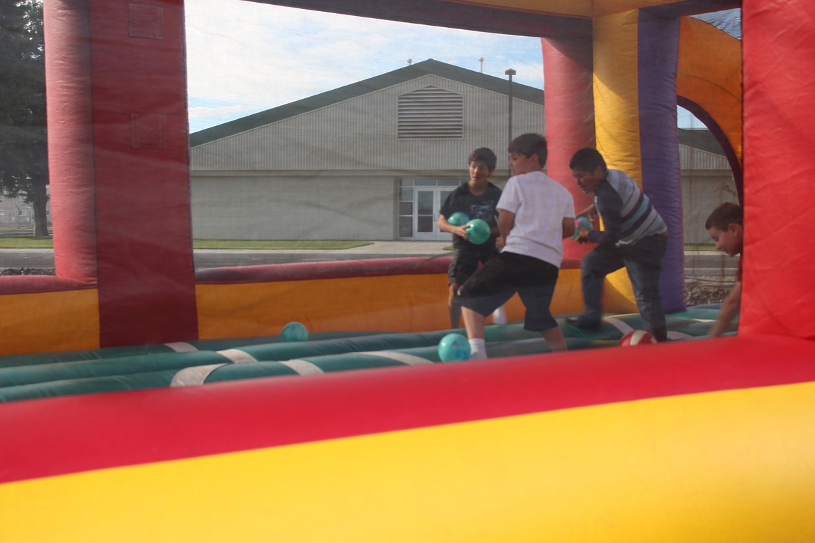 Chanet Stevenson/The Sun Tribune - A bouncy house dodgeball court was a hit with kids at the Othello Community BBQ Friday.