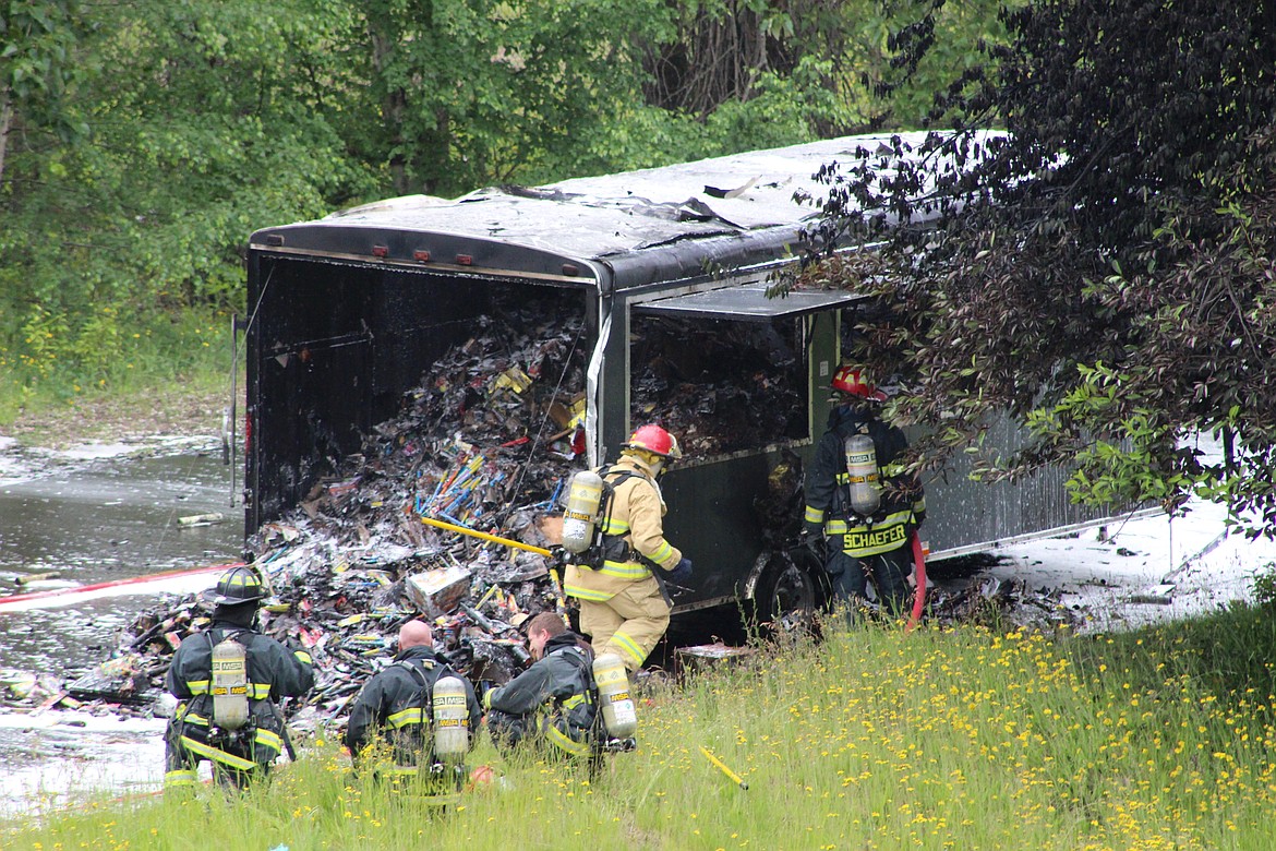 A clear and close shot of the scene reveals a burnt out trailer nearly packed to the brim with fireworks.