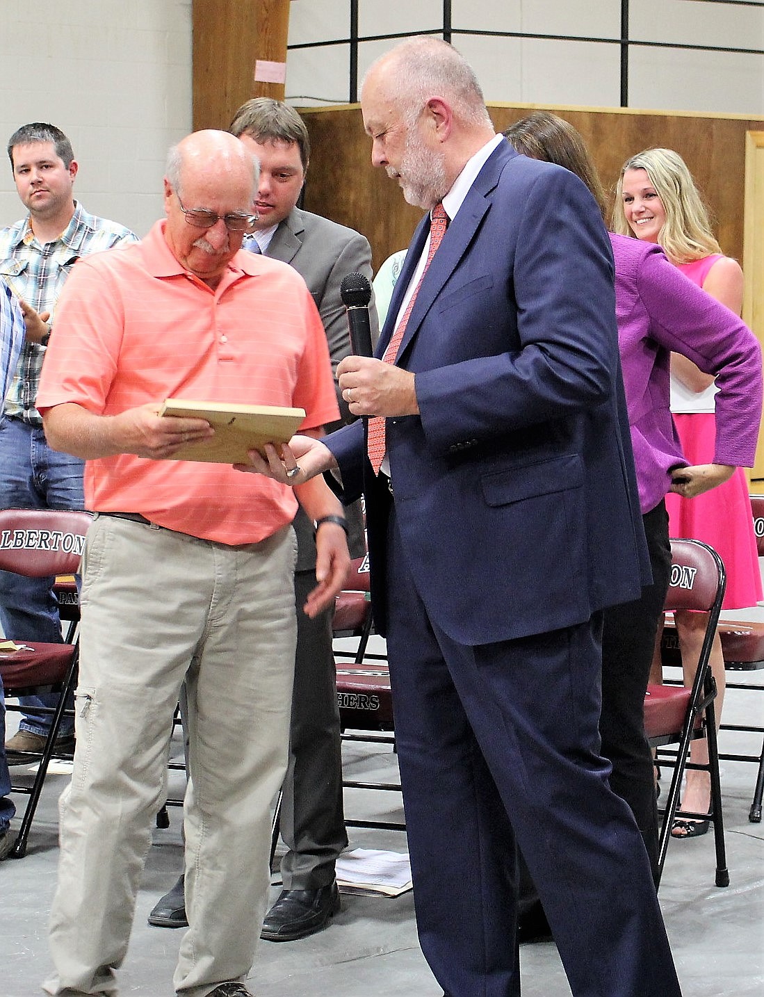 Retired Alberton math teacher Glen Teeters received a plaque of recognition from Superintendent Clay Acker during graduation ceremonies in May. Teeters is retiring from his position as transportation director and Acker is also retiring. (Kathleen Woodford/Mineral Independent).