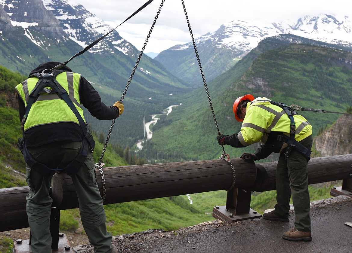 Workers install a guardrail on the Going-to-the-Sun Road at Haystack Falls in Glacier National Park on Friday. (Aaric Bryan/Daily Inter Lake)