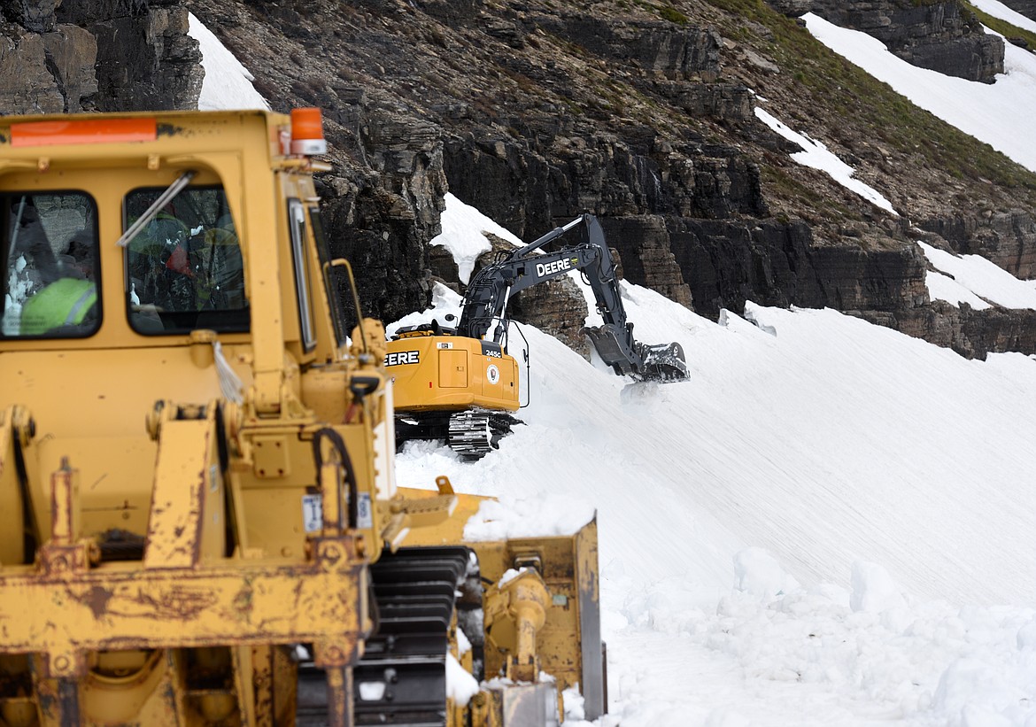 An excavator clears a path for a bulldozer at the Big Drift on the Going-to-the-Sun Road at Glacier National Park on Friday. (Aaric Bryan/Daily Inter Lake)