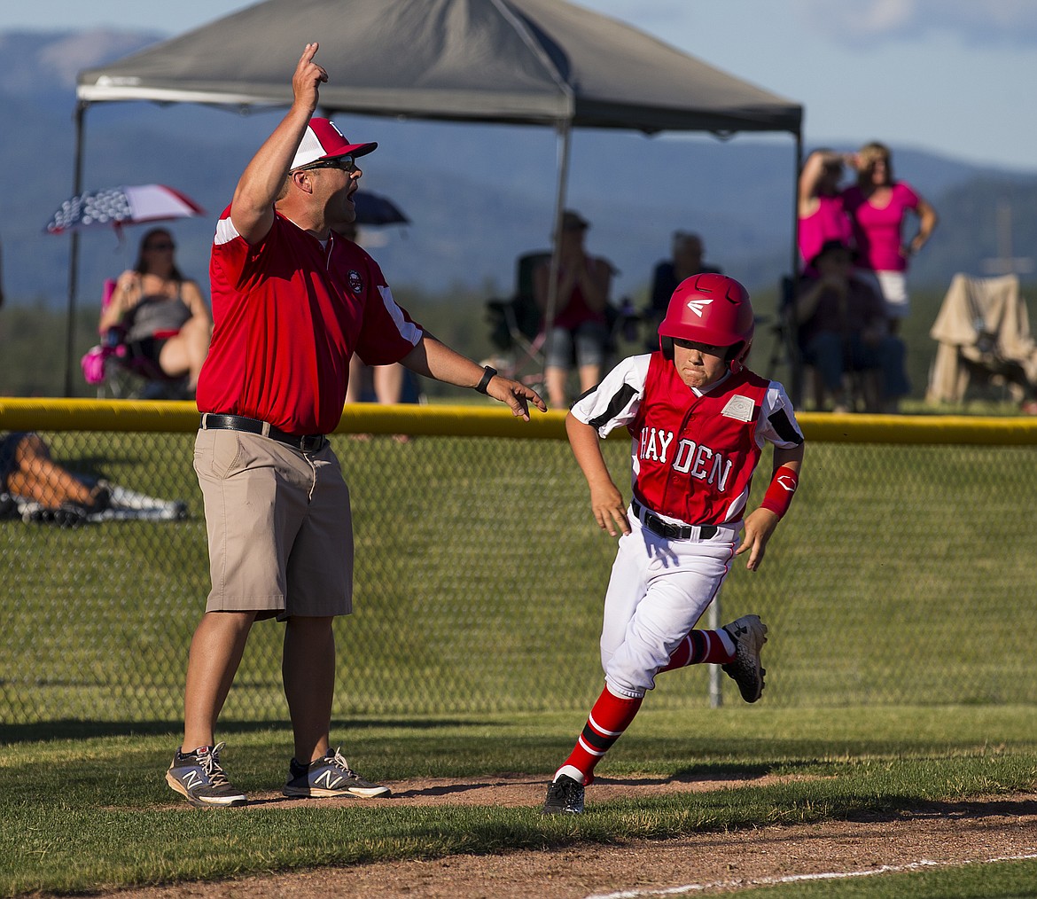 LOREN BENOIT/Press

Hayden&#146;s Isaac Rook rounds third base to score on a hit during a Little League District 1 game against Coeur d&#146;Alene Black Thursday evening at Croffoot Park.