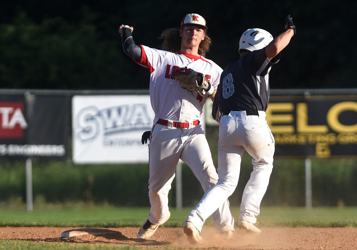 Kalispell Lakers second baseman Adam Joy throws to first on an attempt of a double play against the Glacier Twins at Griffin Field on Thursday. (Aaric Bryan/Daily Inter Lake)