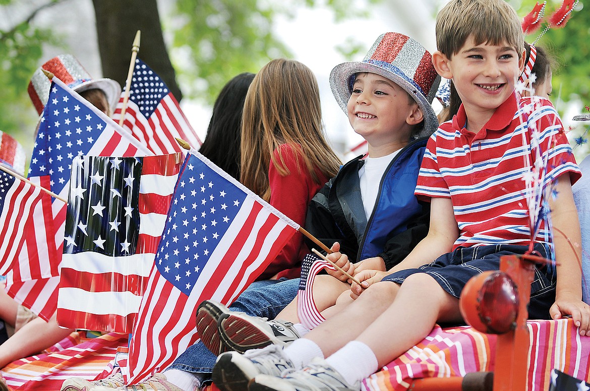 BENNETT DYKSTRA right, and his brother Ethan Dykstra, both of Kalispell, take in the view as they wait for the beginning of the Fourth of July Parade. (Brenda Ahearn/Daily Inter Lake, file)