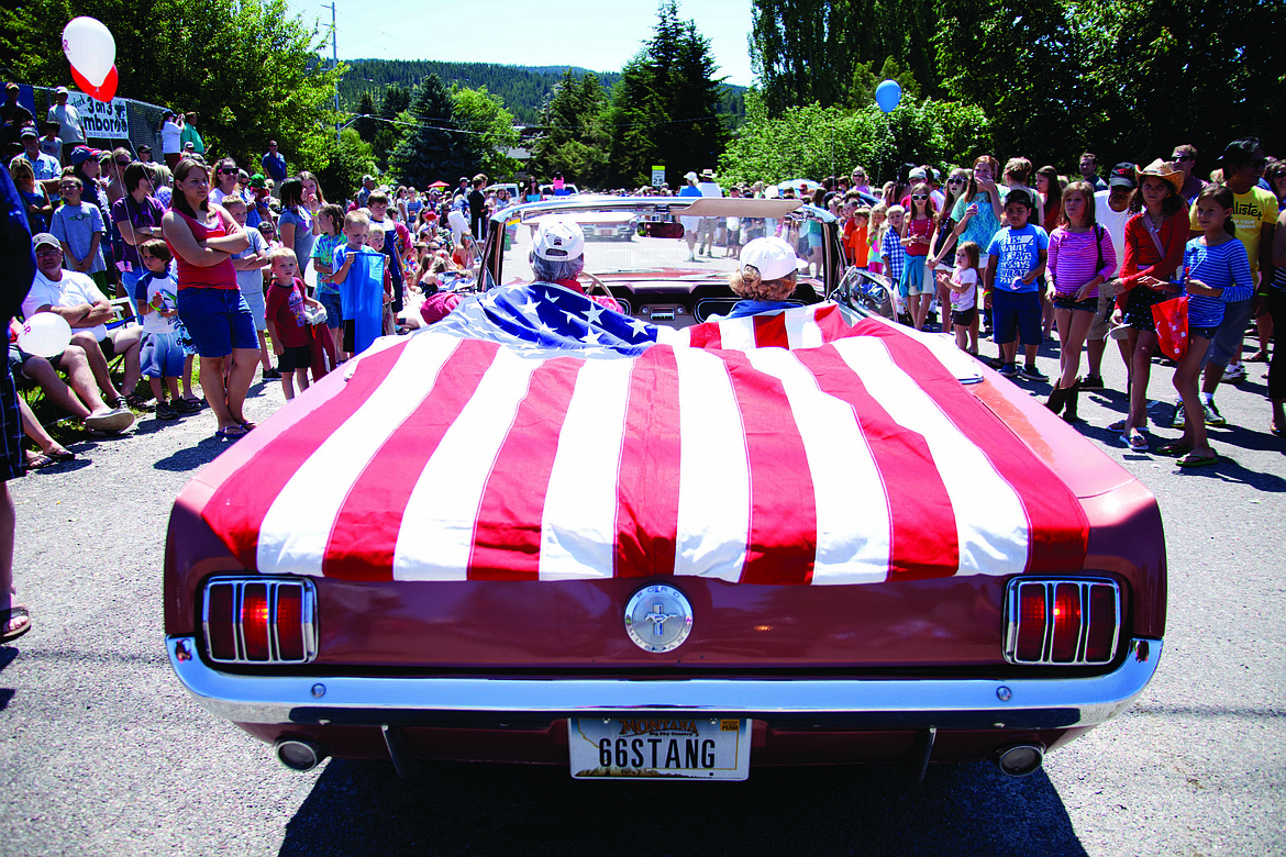 PARADE-GOERS line both sides of Grand Drive in Bigfork during the city's annual Fourth of July parade. (Patrick Record/Daily Inter Lake, file)