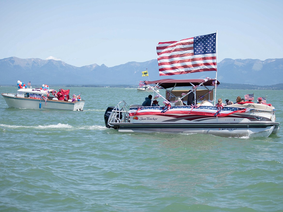 BOATS MAKE their way to Somers as part of the Flathead Lake Fourth of July both parade, which starts in Lakeside. (Patrick Record, Daily Inter Lake, file)