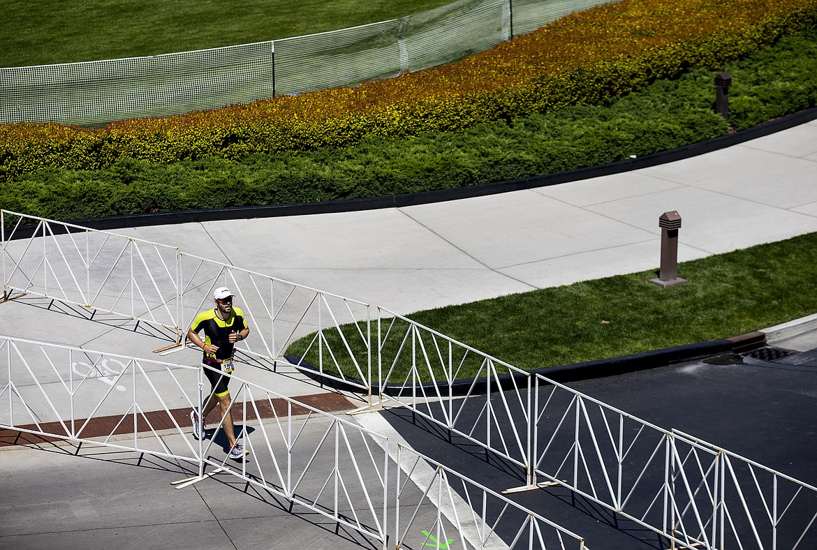 LOREN BENOIT/PressKevin Ormiston runs near The Coeur d'Alene Resort during Ironman Coeur d'Alene 70.3 on Sunday.