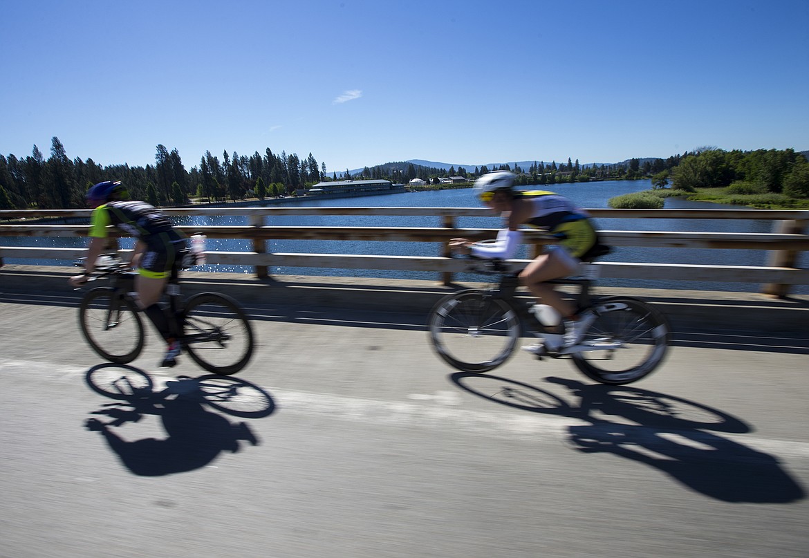 LOREN BENOIT/PressIronman cyclists cross the Spokane River bridge on U.S. 95.