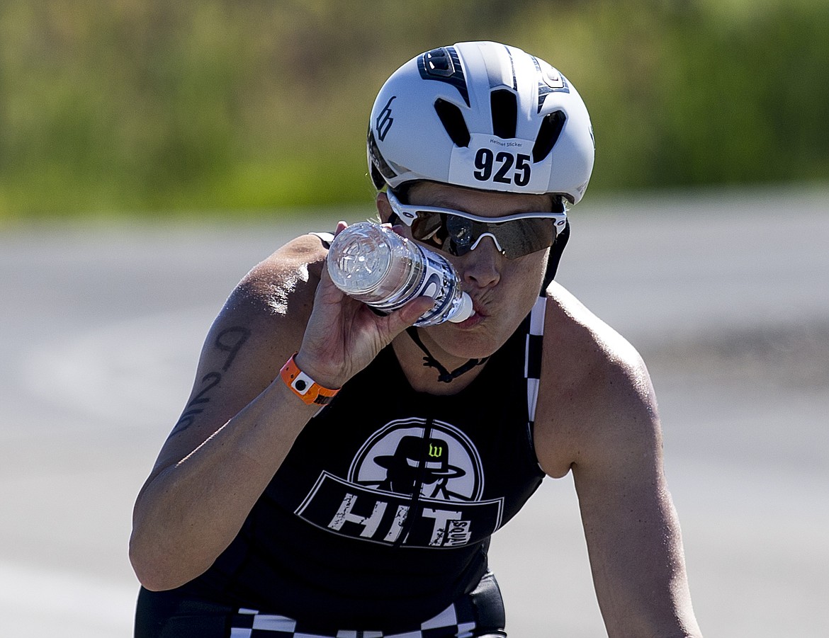 LOREN BENOIT/PressAnne McBeth of Canda takes a swig of water as she bikes on U.S. 95 south of Coeur d'Alene during Ironman Coeur d'Alene 70.3.