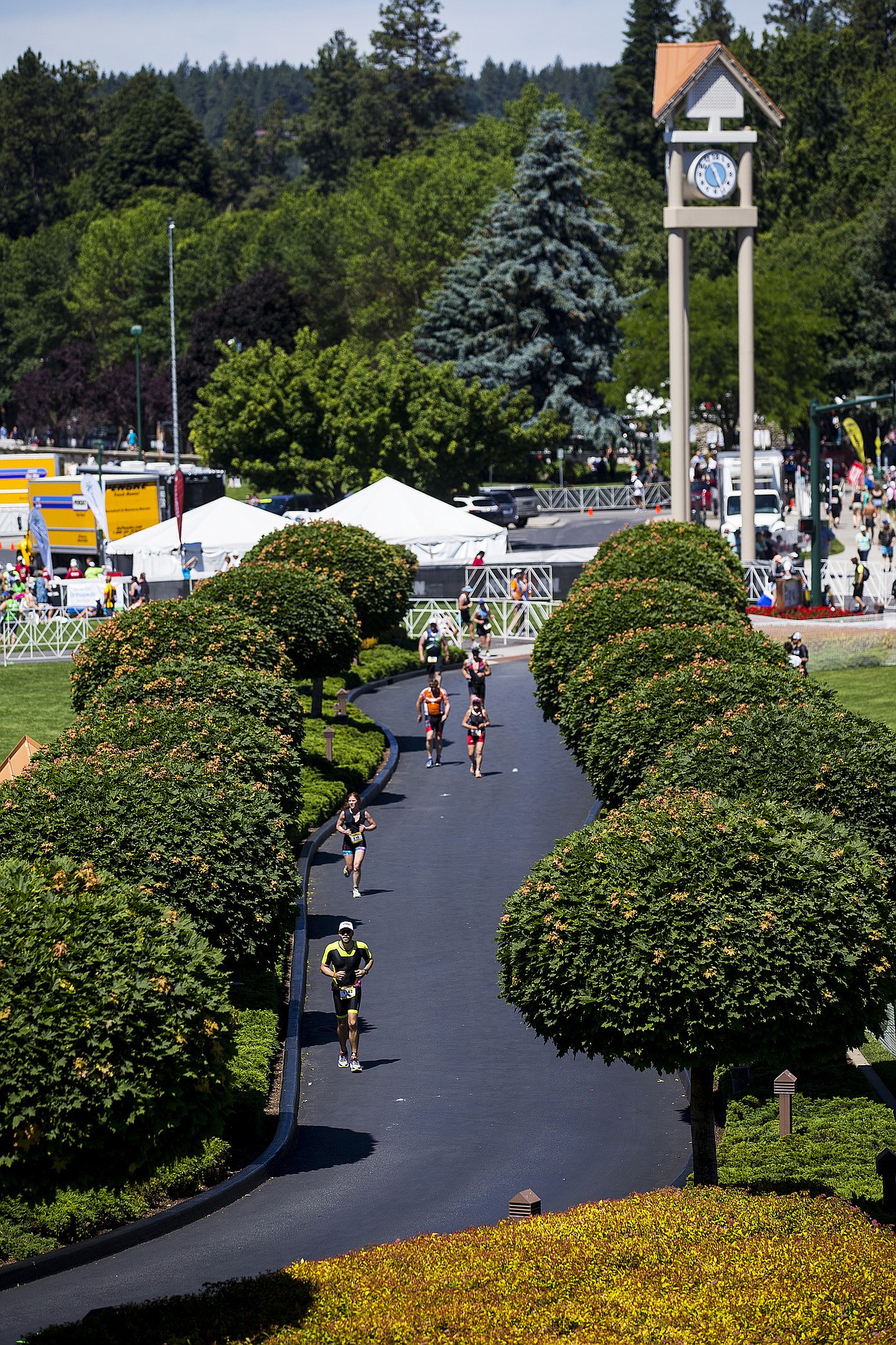 LOREN BENOIT/PressIronman athletes run on the main roadway to the Coeur d'Alene Resort during Ironman 70.3 Coeur d'Alene.