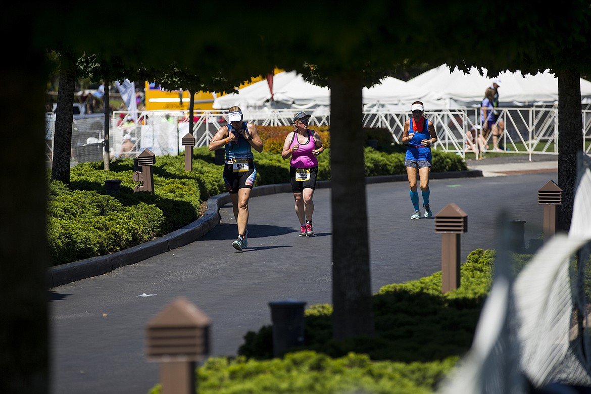 LOREN BENOIT/PressA trio of Ironman athletes compete in the running leg portion of Ironman 70.3 Coeur d'Alene.