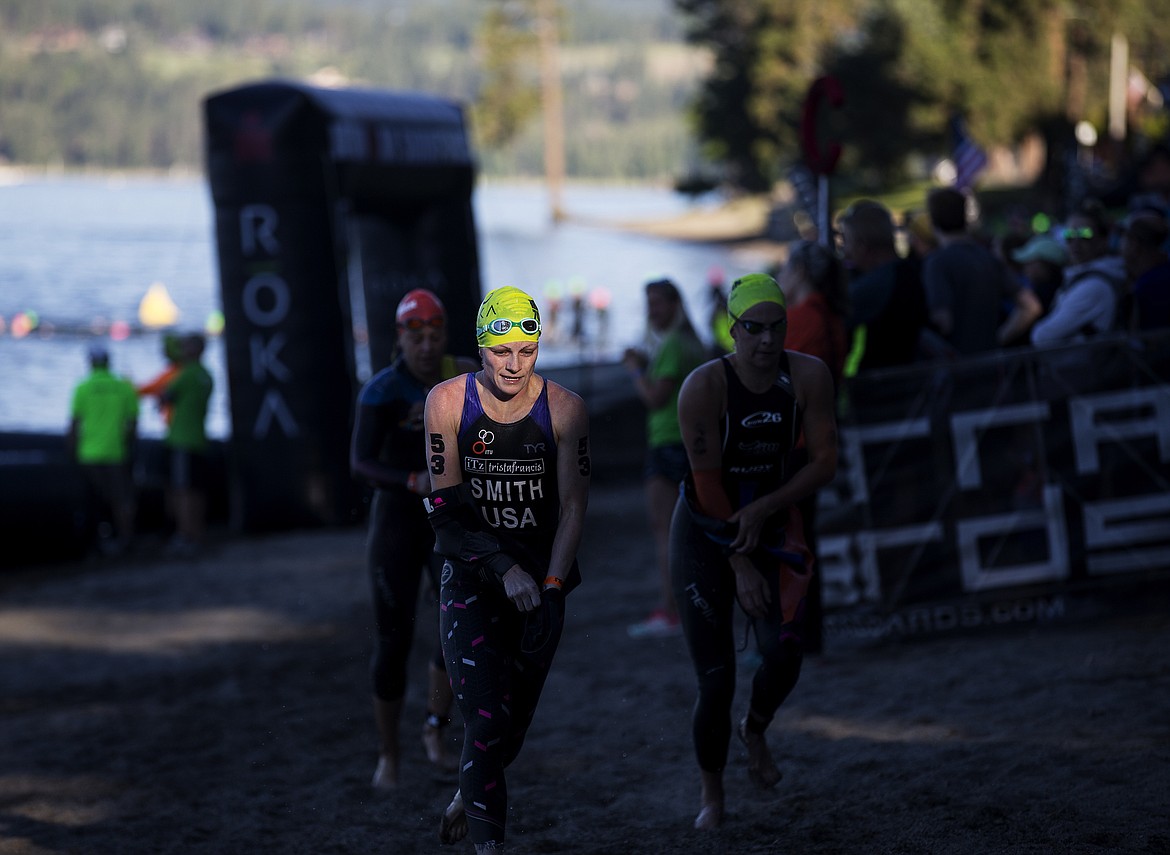 LOREN BENOIT/PressSierra Smith starts to remove her wetsuit as she transitions to the bike leg portion of the Ironman race.