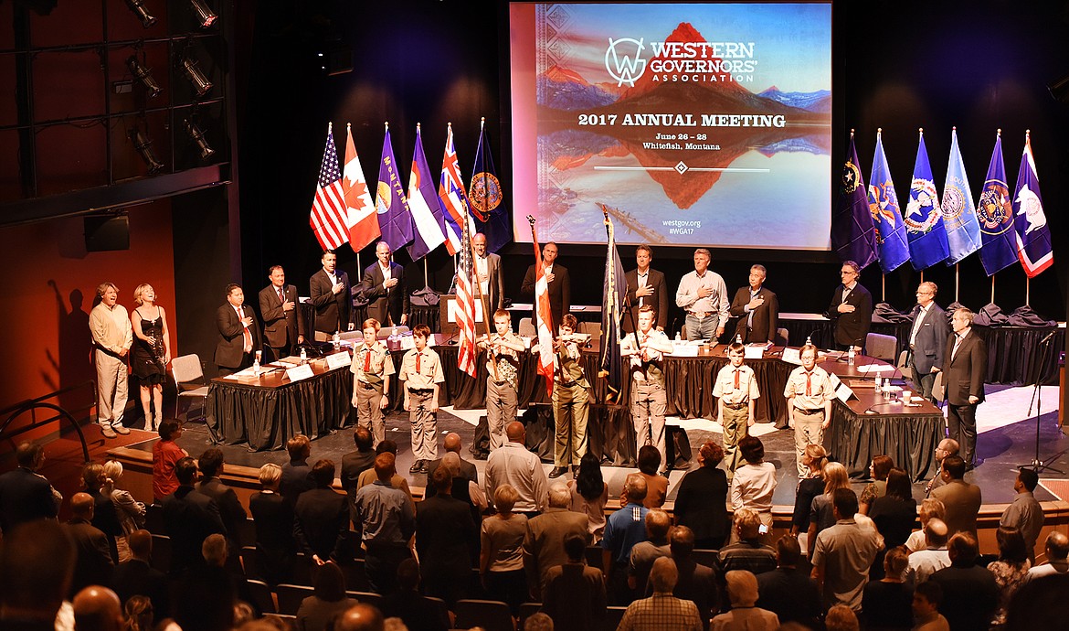 Attendees of the 2017 Western Governors&#146; Association annual meeting stand for the presentation of the flags by Whitefish Boy Scout Troop 1917 on Monday afternoon as Luke Walrath and Betsi Morison of the Alpine Theatre Project sing both the &#147;Star-Spangled Banner&#148; and &#147;O Canada&#148; at the meeting&#146;s opening event at the Whitefish Performing Arts Center on Monday. (Brenda Ahearn photos/Daily Inter Lake)