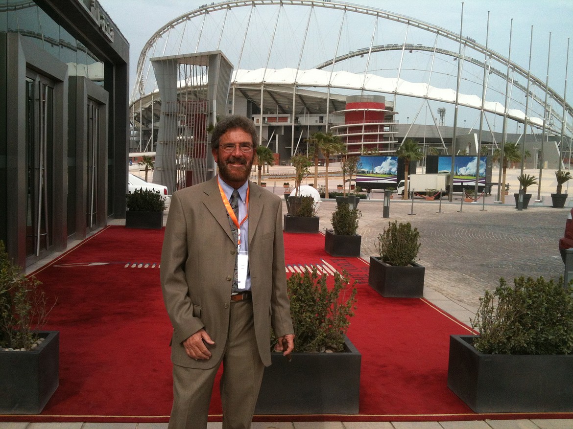 Courtesy photo
Steve Cameron takes a break from moderating a 2012 international conference at The Torch in Doha, Qatar, with Al Khalifa Stadium in the background.