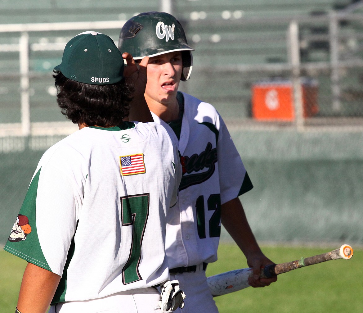 Rodney Harwood/Columbia Basin HeraldCentral Washington Spuds Cameron Duke is congratulated after scoring in the eighth inning of Tuesday's AAA 19U game at Larson Playfield.