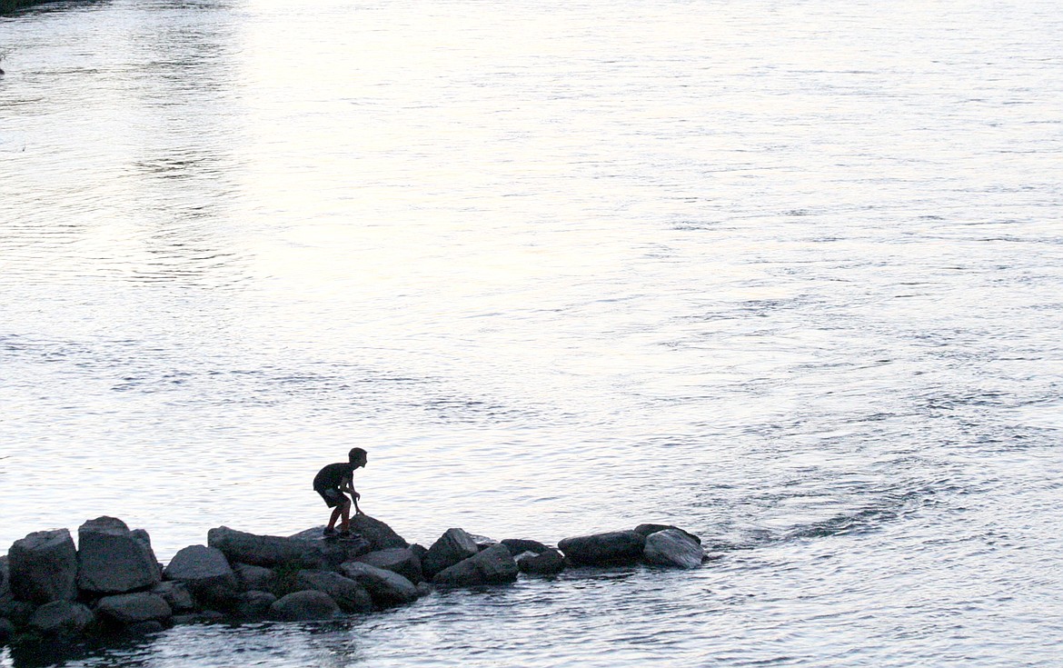 A boy waits to collect the discs that almost made it across the Kootenai. (Elka Wood/The Western News)