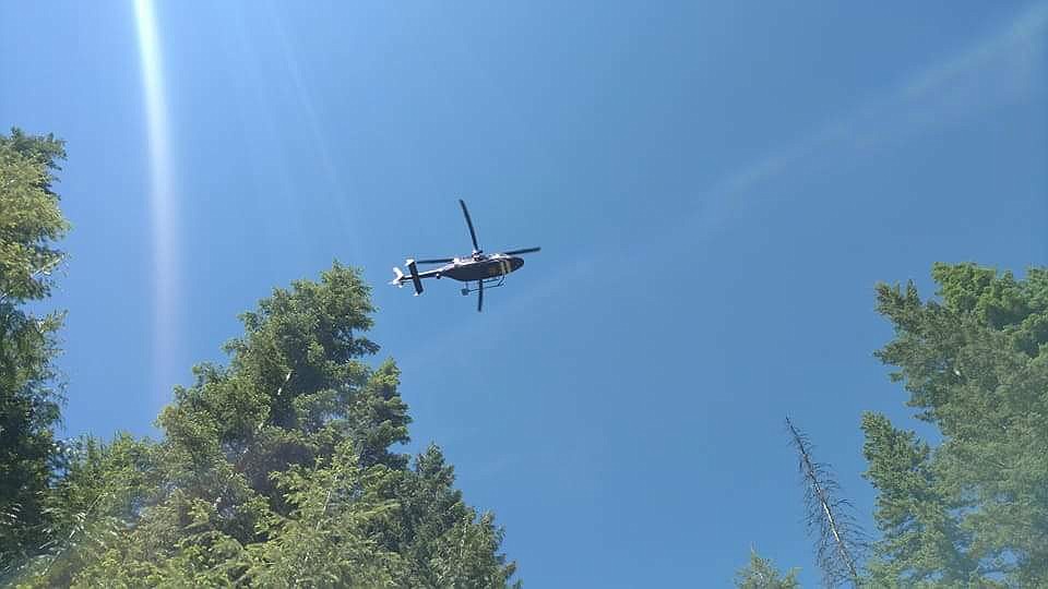 Photo courtesy of West Millward. 
A Two Bear Air helicopter leaves the scene carrying the injured man.