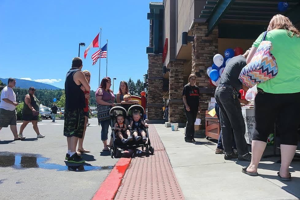 Enticed by the smell of a summer barbecue, families lined up for burgers and brats.