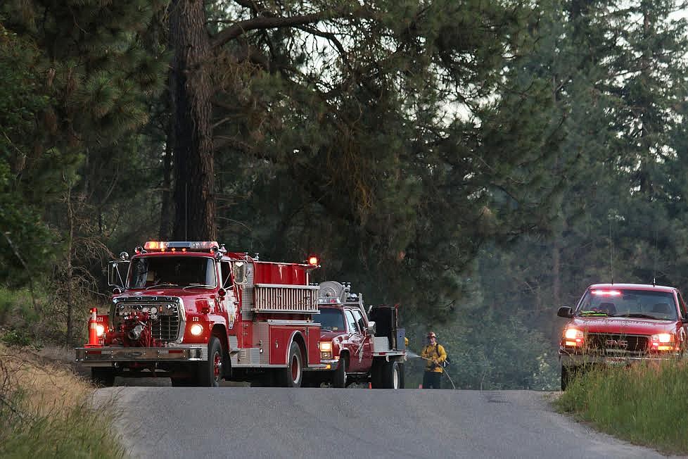 Photos by Mandi Bateman
A fire broke out on Riverside Road, just west of the city limits, on Sunday, June 25, around 8 p.m. A large tree caught fire, along with the surrounding brush. North Bench Fire Department responded, with assistance from South Boundary Fire Department, which brought a water tender. The fire was contained quickly by the crew. The area is a notorious hotspot as tourism increases, and people throw lit cigarette butts out their car windows. &#147;Out here, it seems the last couple of years, we&#146;ve had it in July or August,&#148; said North Bench Fire Chief Gus Jackson, who was the incident commander at the scene.