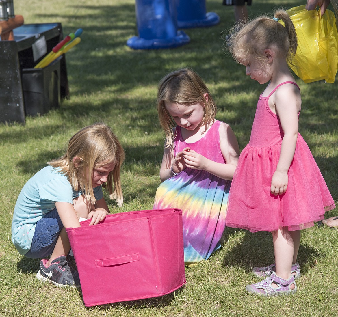 Sister tots pick prizes after playing one of the kids games at the summer kick-off.