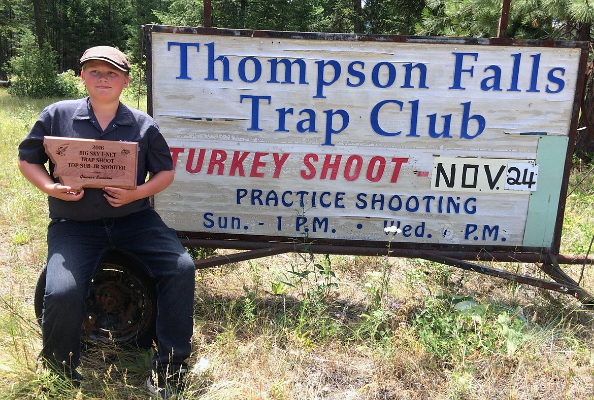 GUNNER SWANSON, of Noxon, is part of Thompson Falls Trap Club&#146;s initiative to generate interest among younger shooters. Swanson is holding his award he received for the top junior shooter in the Big Sky Trap Shoot outside the Thompson Falls Trap Club building. (photo courtesy of Digger Powell)