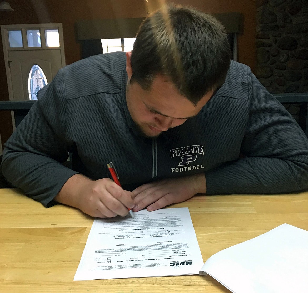 FORMER POLSON Pirates' offensive lineman inks a deal with Minot State, an NCAA Division II program, for the 2017 college football season. (Photo courtesy of Bob Corley)