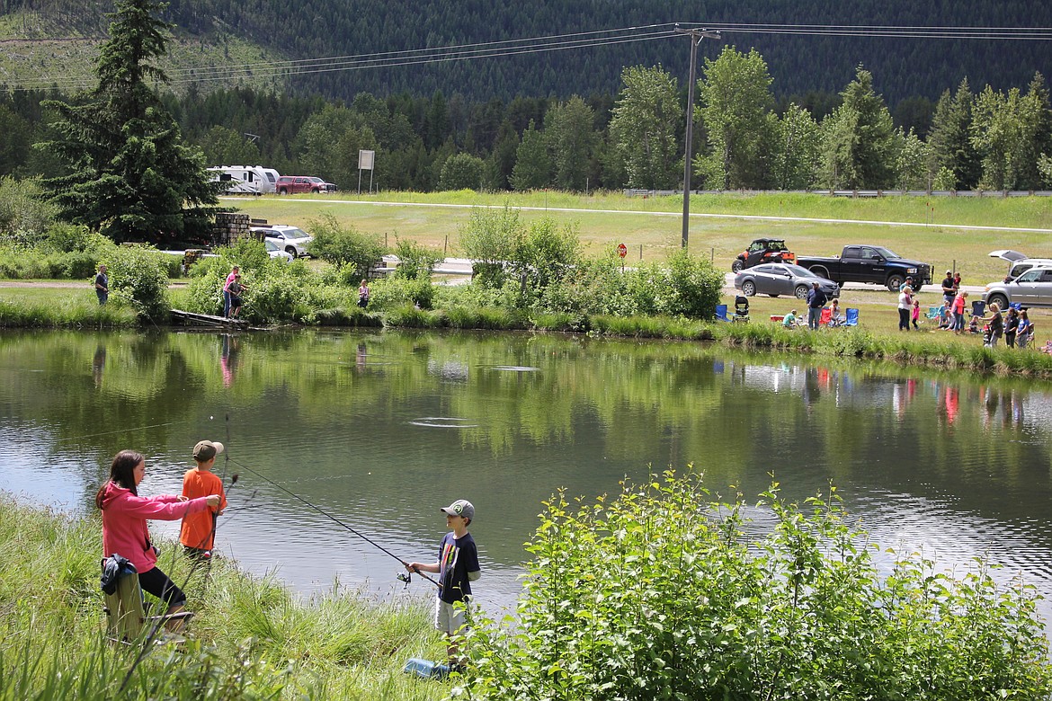 Families gathered around Savenac Pond on June 17, to enjoy a day of fishing and fun sponsored by Fish, Wildlife and Parks at Haugen, MT. (Kathleen Woodford/Mineral Independent).