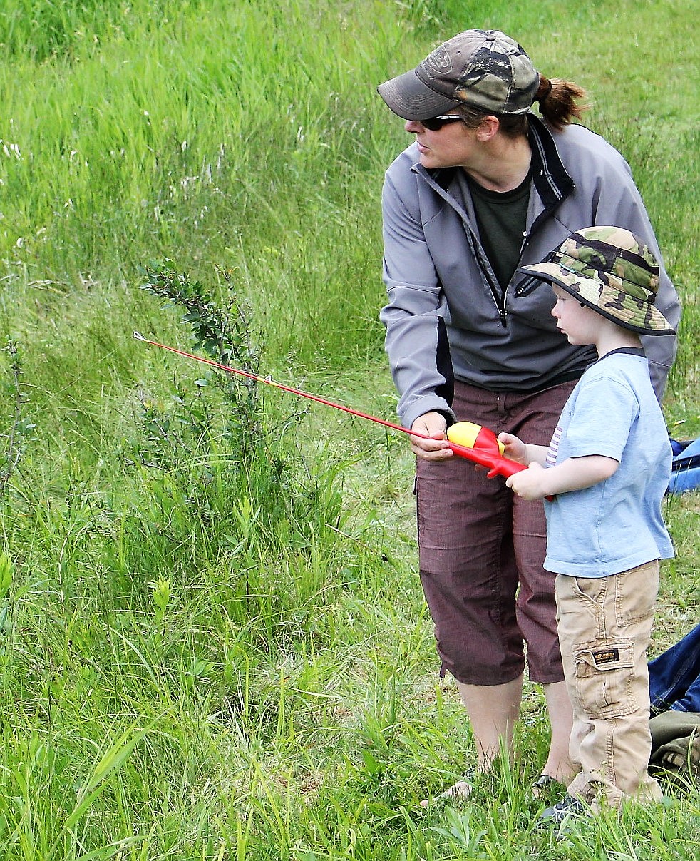 OTTO LORAS, 5, gets help from mom, Lauri Cotter, during Fishing Day at Savenac on June 17.