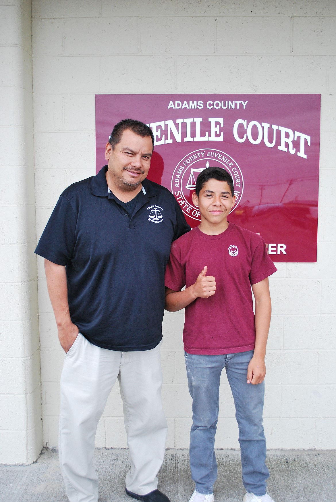 Bob Kirkpatrick/The Sun Tribune - Adams County Probation Councilor and Juvenile Detention Alternative Coordinator Benny Medina with Boys Council graduate Angel Valencia.