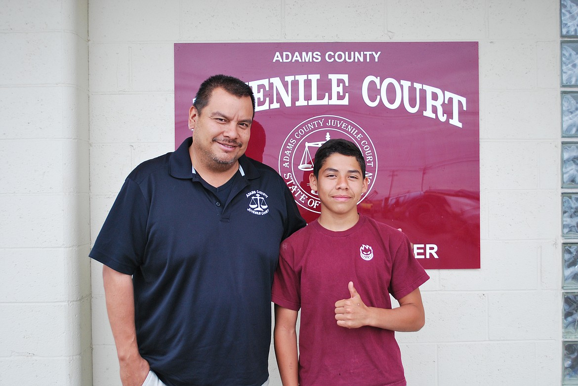 Bob Kirkpatrick/The Sun Tribune - Adams County Probation Councilor and Juvenile Detention Alternative Coordinator Benny Medina with Boys Council graduate Angel Valencia.