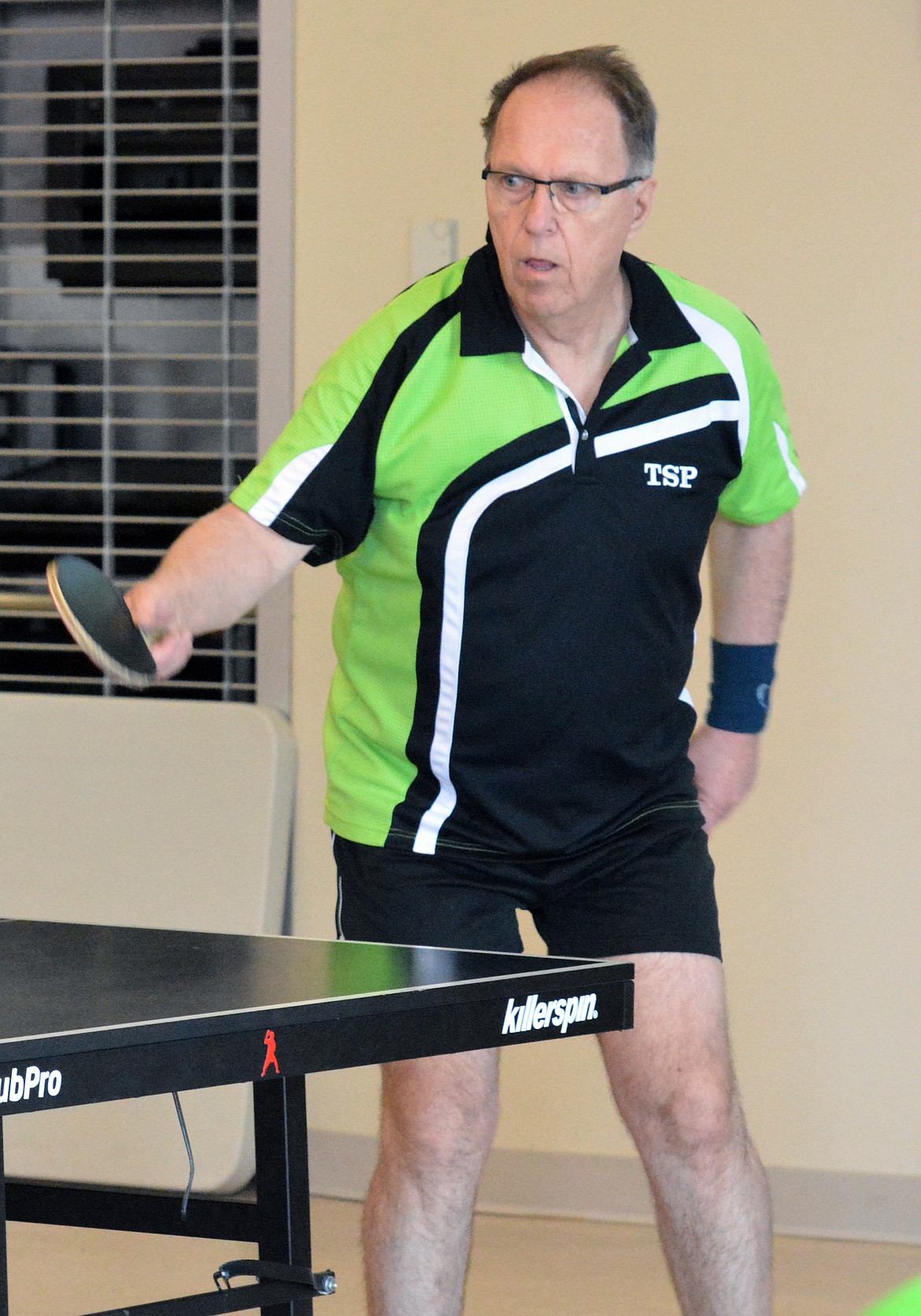 SENIOR OLYMPIC table tennis player Gary Pastushok returns an offering from his opponent during the Senior Olympics portion Saturday at Salish Kootenai College in Joe McDonald Gym. Pastushok , a level 2,000 player, came all the way from Bismarck, ND, to play with several local table tennis players. (photo by Jason Blasco/Lake County Leader)