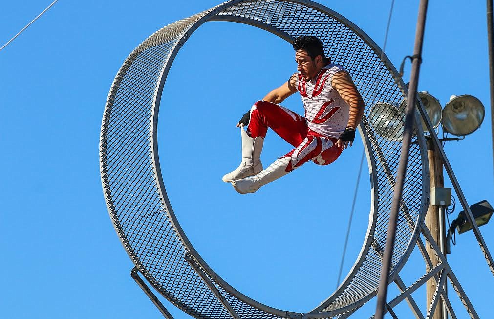 Photo by Mandi Bateman
Saturn Garcia defies gravity in a giant, spinning wheel during the Jordan World Circus.