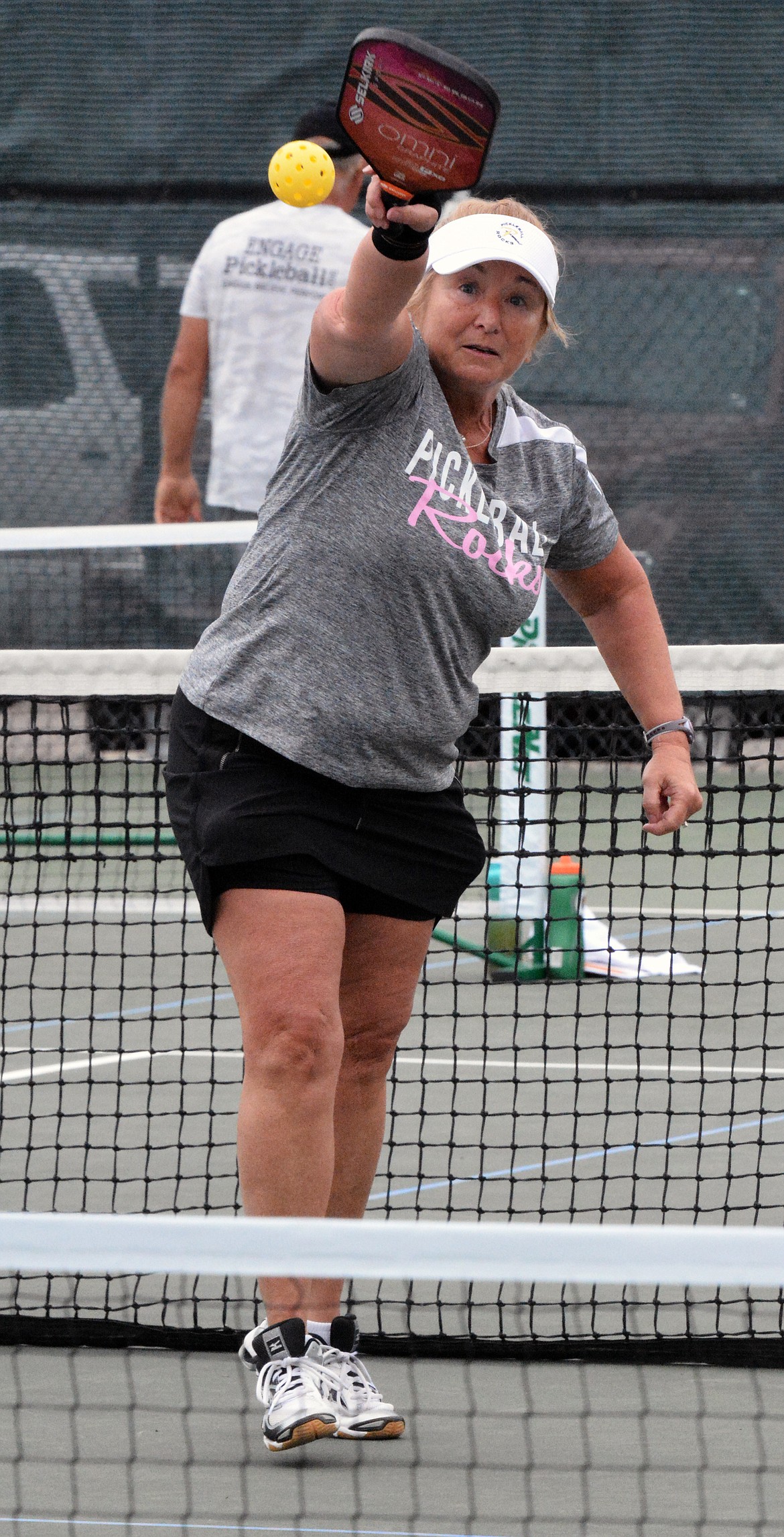 PICKLEBALL PLAYER Paulette Patterson, from Great Falls, returns a serve in a Pickleball contest at the Polson Tennis Courts at Linderman Elementary School. (Jason Blasco/Lake County Leader)