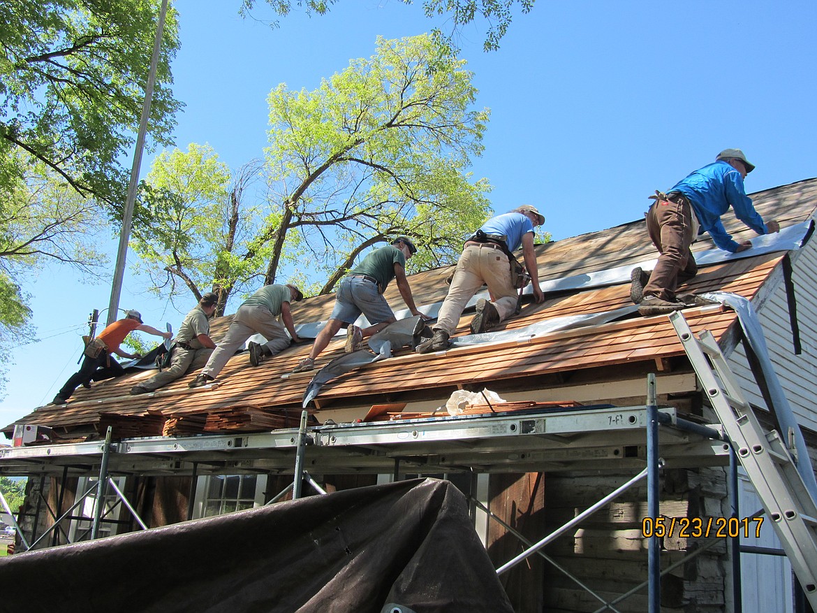 VOLUNTEERS work to replace the roof on the Old Schoolhouse in Plains earlier this year. The project took nearly two weeks to complete. (Photos courtesy Plains Woman&#146;s Club)