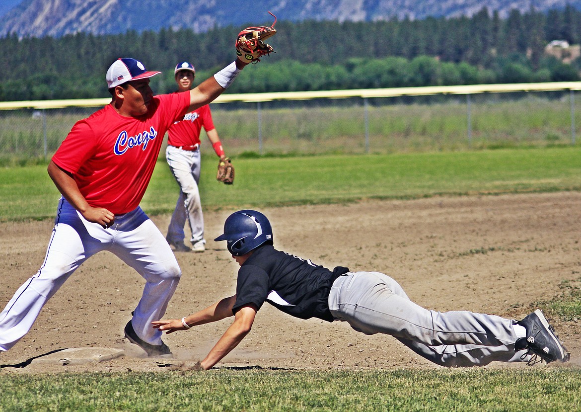 CLARK FORK third basemen Esvin Reyes from Plains, with the ball trying to tag the runner from Mission as he dives back for a safe in a regular season game. (Photo courtesy of Jessica Peterson)