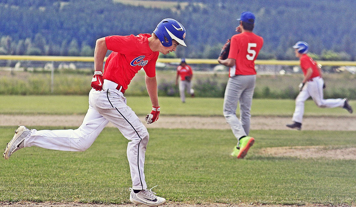 CLARK FORK batter Logan Woods &#160;runs to first base as Trevor Harris steals third base in a regular season game. (photo courtesy of Jessica Peterson)