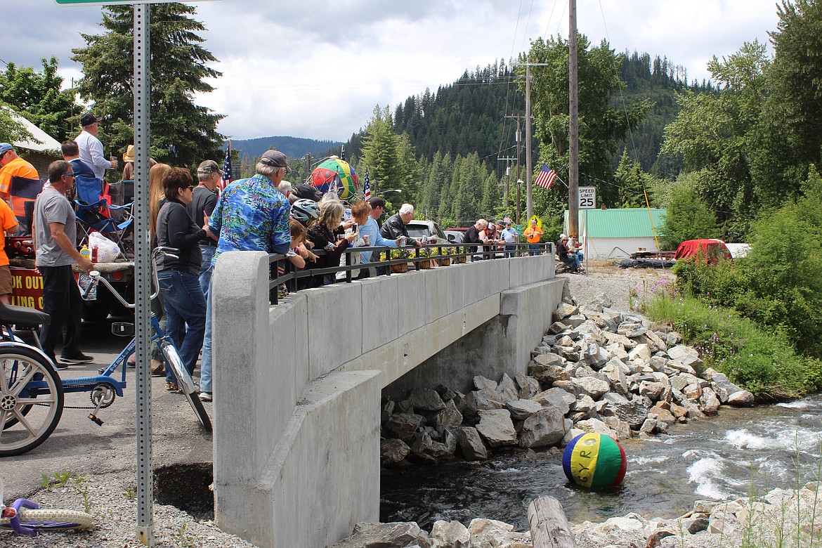 Onlookers watch the ball go under the River Street bridge in Mullan.