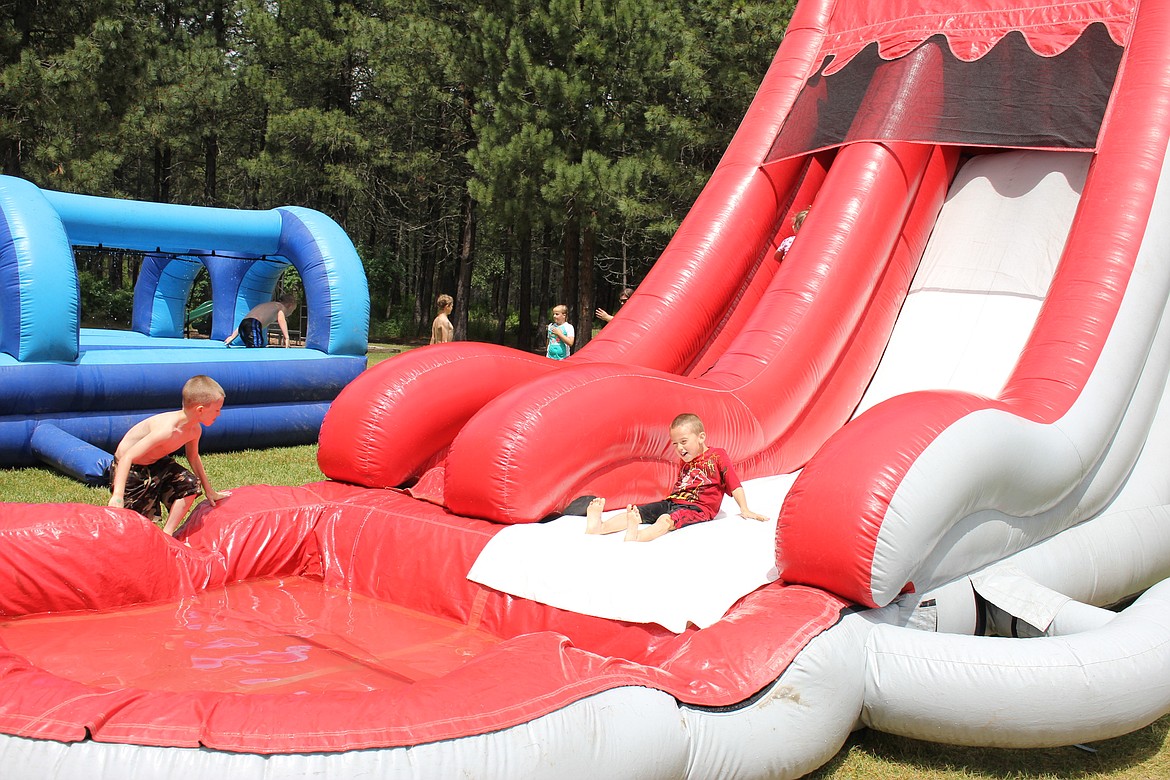 St. Regis baseball players enjoy a giant water slide at St. Regis Park last Saturday, June 17. (Kathleen Woodford/Mineral Independent)