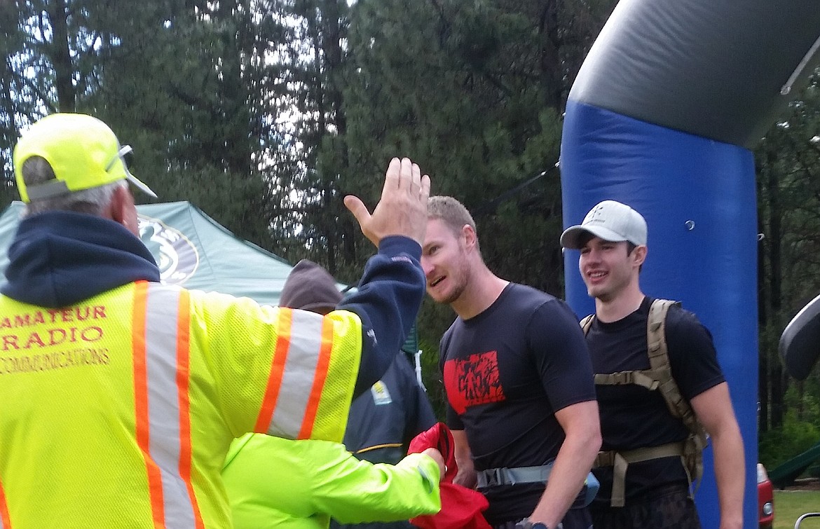 Two final 50 Mile runners receive a high-five as they cross the finish line at St. Regis Park during the Trail Rail Run on June 10. (Photo courtesy of Tyler Cheesman)