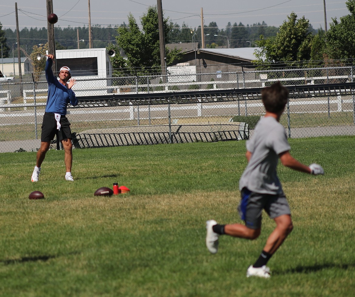 ERIC PLUMMER/Bonner County Daily Bee
NFL quarterback Brock Osweiler, who was born in Coeur d'Alene, launches a pass to a high school receiver Friday at Coeur d'Alene High.