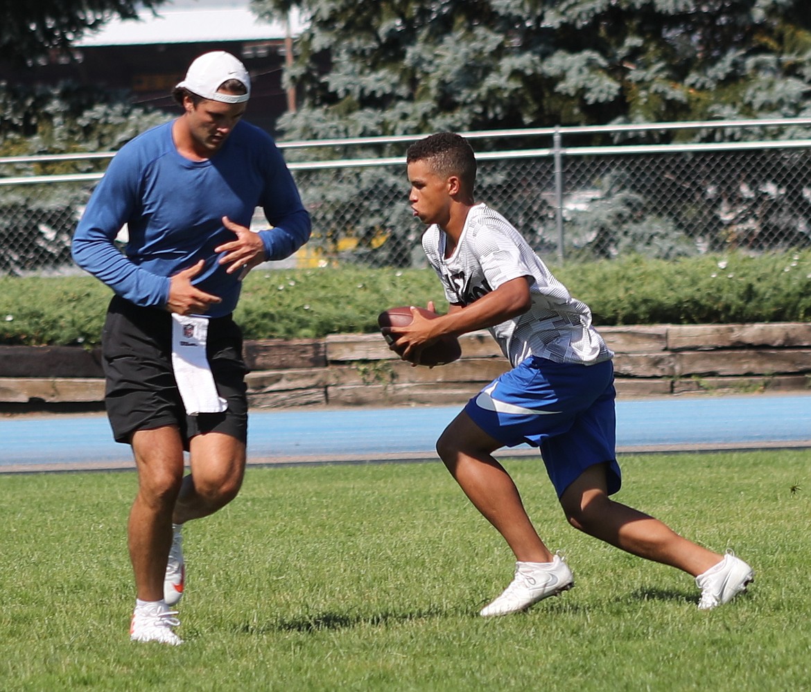 ERIC PLUMMER/Bonner County Daily Bee
Brock Osweiler plays the role of running back as Devin Johnson, who will be a sophomore at Coeur d'Alene High, practices play-action passes Friday at Coeur d'Alene High.