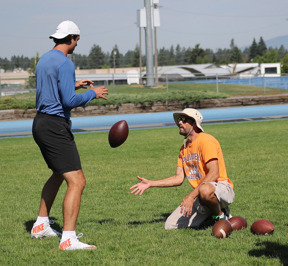 ERIC PLUMMER/Bonner County Daily Bee
Former NFL quarterback Jake Plummer, right, &#147;snaps&#148; the ball to Cleveland Browns quarterback Brock Osweiler during a throwing session/clinic Friday at Coeur d&#146;Alene High.