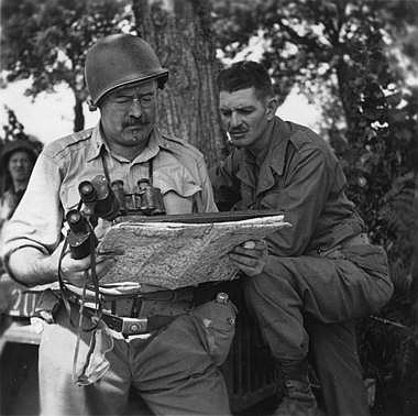 GOOGLE IMAGES
Shown here with an unidentified soldier, war correspondent Ernest Hemingway, right, saw action in France as an unauthorized combatant.