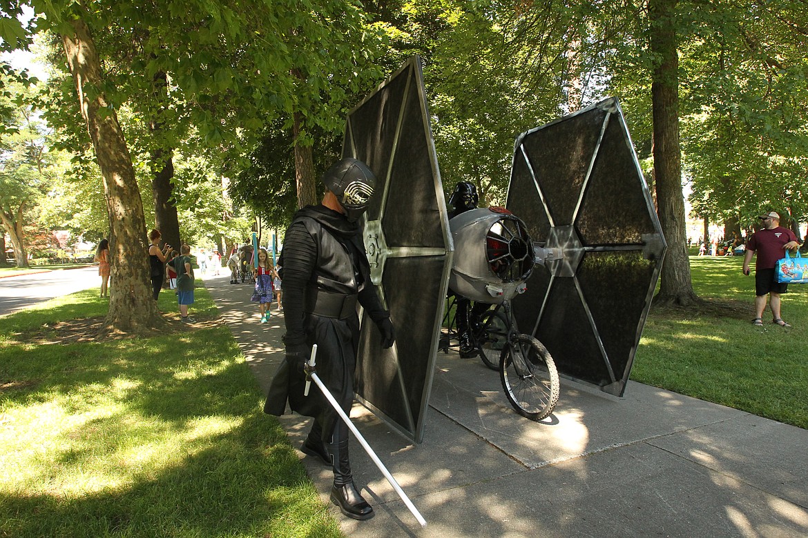 DEVIN HEILMAN/Press
Loren &quot;Darth Vader&quot; Roberts, 14, pilots a homemade &quot;Star Wars&quot; TIE fighter through City Park as her dad, Marty Roberts, dressed as Kylo Ren, leads the way during the GizMotion parade Saturday.