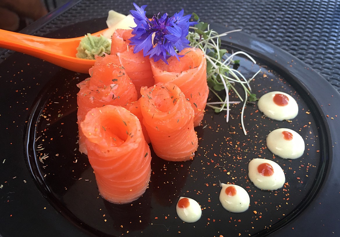Salmon sashimi is served with a blend of spices and herbs, and topped with an edible flower at Indah Sushi. (Mackenzie Reiss/Daily Inter Lake)