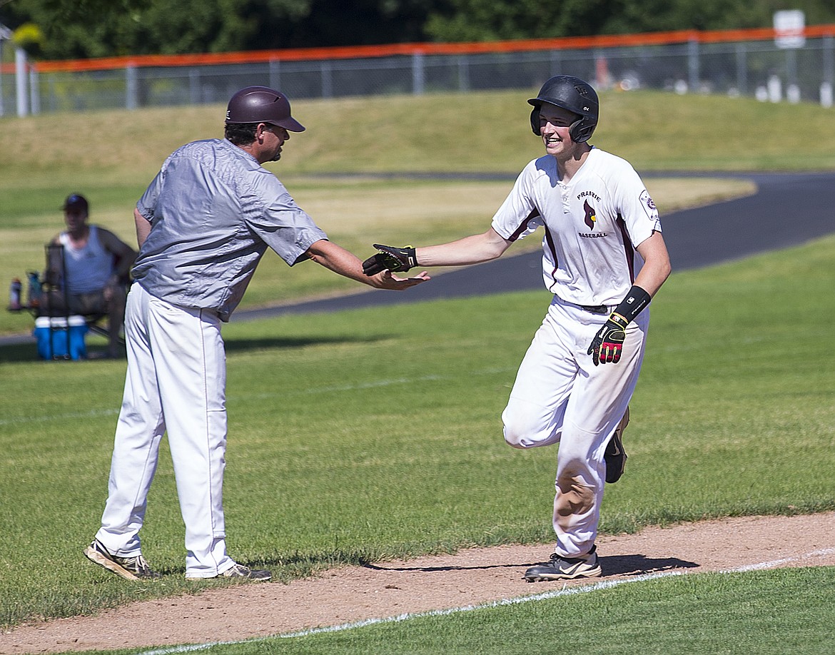 LOREN BENOIT/Press

Prairie&#146;s Preston Benson high-fives his coach, Pat Call, after hitting his second home run of the game against Lewis-Clark Wednesday afternoon at Post Falls High School.