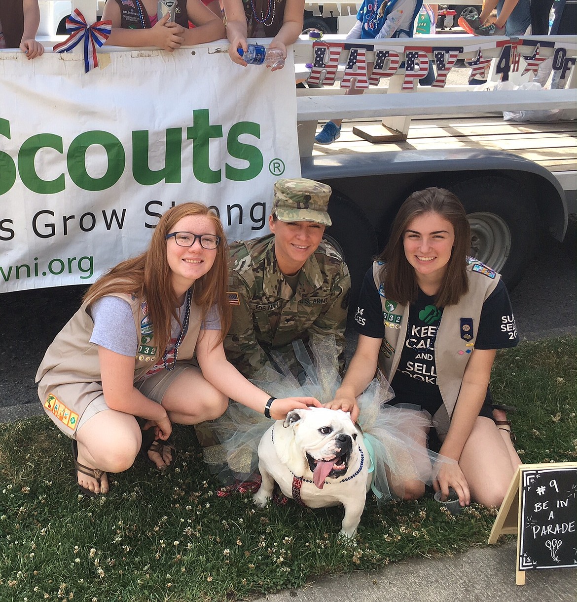 Courtesy photo 
Girl Scout Seniors Avery Gephart, left, and Clare Dolan, right, of Girl Scout Troop 3032 and U.S. Army Specialist Callie L. Edelman and Edelman&#146;s English bulldog, Lulu, pose for a photo near the troop&#146;s float in Coeur d&#146;Alene&#146;s Fourth of July parade. Edelman and Lulu marched in the parade with the Girl Scouts.